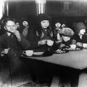 ELEMENTARY SCHOOL, c1920. Students eating lunch at an elementary school in New York City